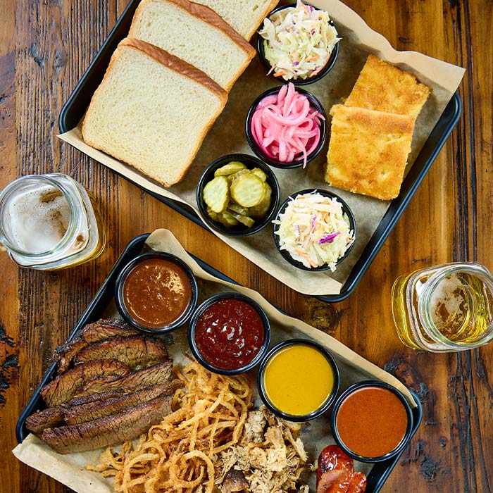 BBQ platter served with sides and sauces served at Cowboy Mac's Country Club Restaurant and Bar located in Green Bay, Wisconsin