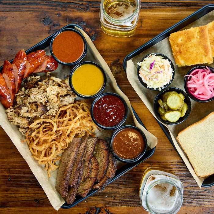 BBQ platter served with sides and sauces served at Cowboy Mac's Country Club Restaurant and Bar located in Green Bay, Wisconsin BBQ platter served with sides and sauces served at Cowboy Mac's Country Club Restaurant and Bar located in Green Bay, Wisconsin