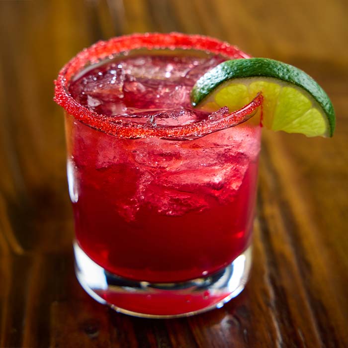 Pink red margarita with lime wedge served at Cowboy Mac's Country Club Restaurant and Bar located in Green Bay, Wisconsin Pink red margarita with lime wedge served at Cowboy Mac's Country Club Restaurant and Bar located in Green Bay, Wisconsin